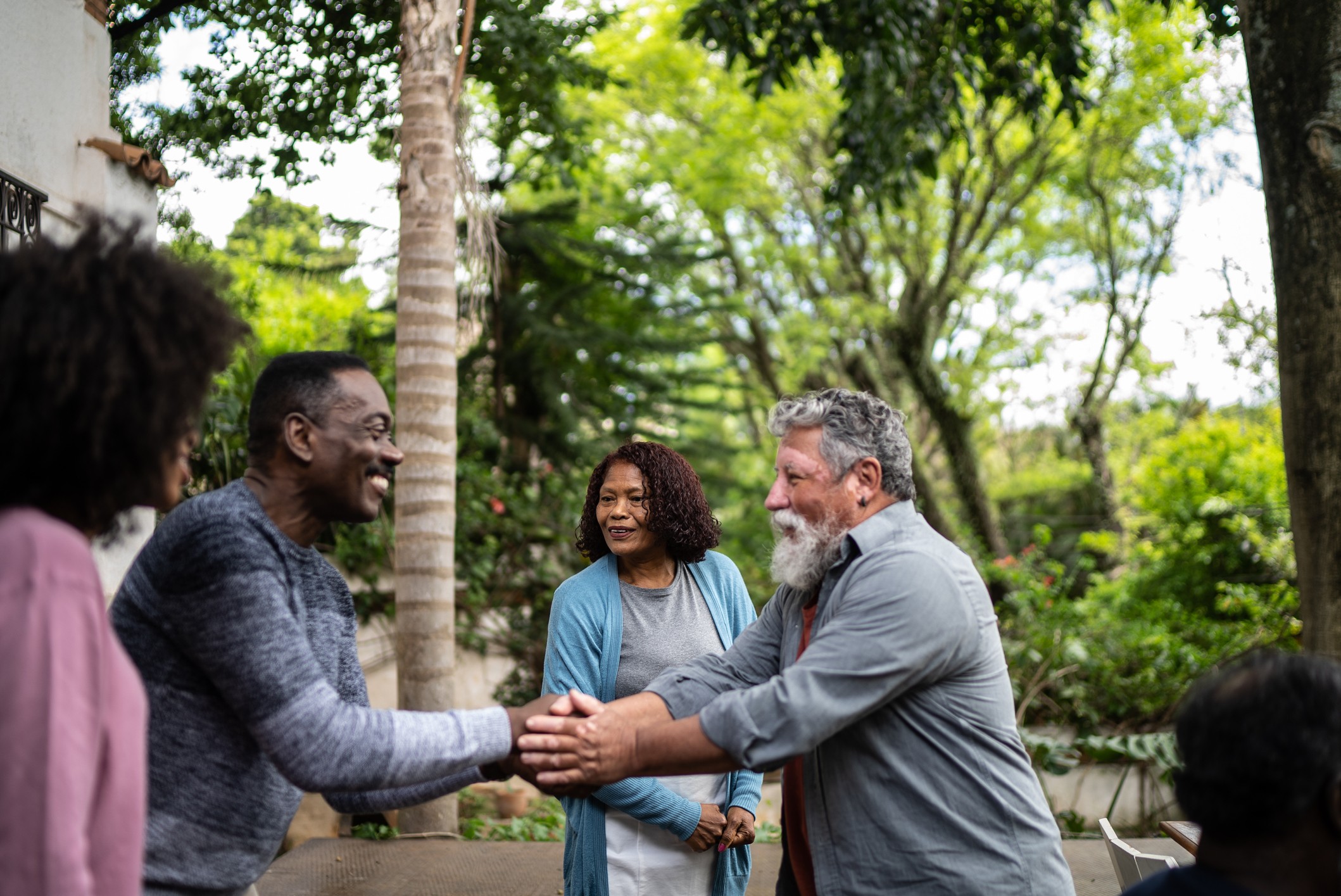 Neighbors greeting each other at the front of the house