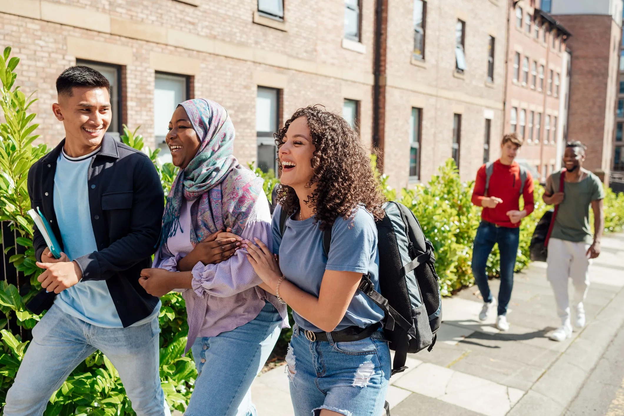 University students walking to university through the city center of Newcastle upon Tyne, North East England